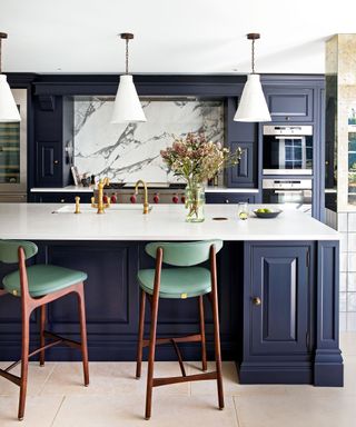 navy blue kitchen with island and bar stools