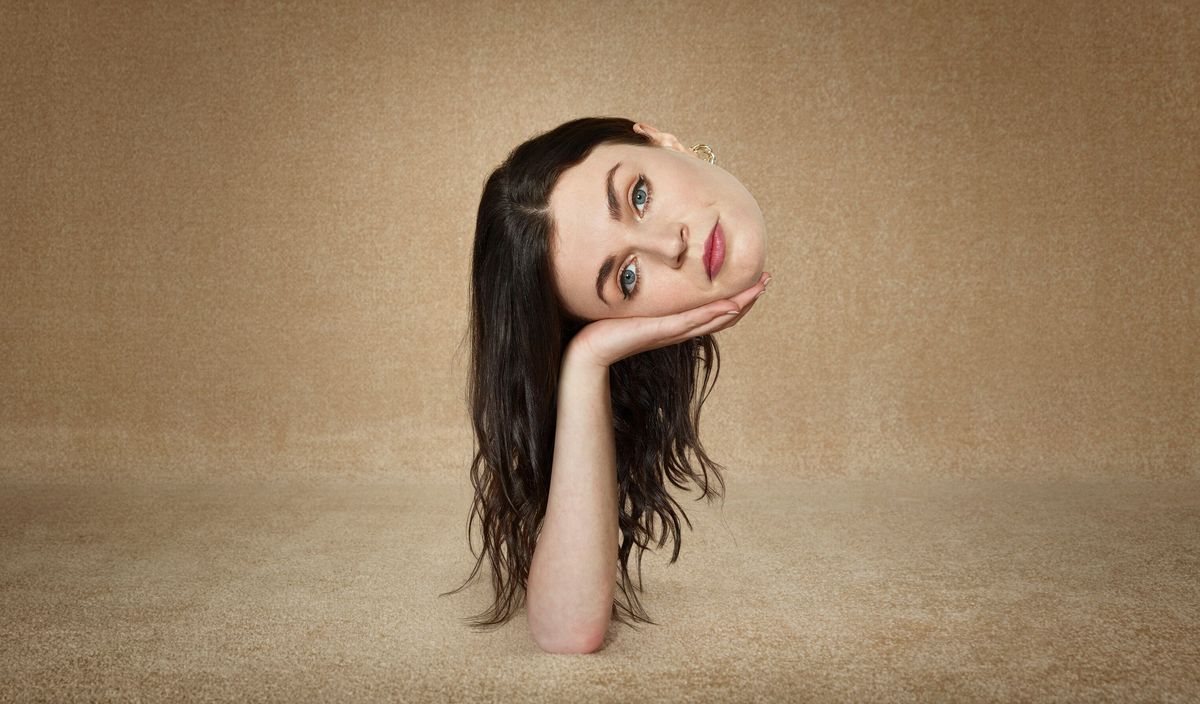 This Way Up Season 2: a shot of Áine&#039;s (Aisling Bea) disembodied head being held up by a hand that is sticking up out of the ground 