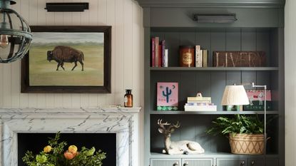living room with shelving, marble fireplace and western decor
