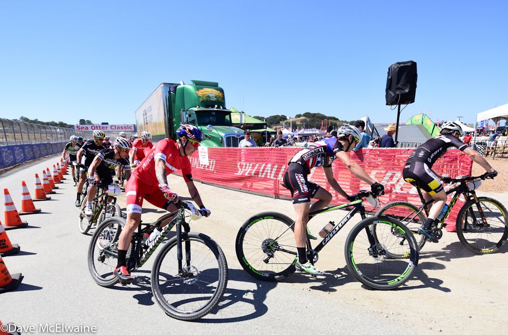 Racers round a turn before the flyover used in the cyclocross race
