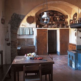 kitchen with damaged wall and copper vessel