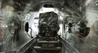 A view of the spectrometer being slid into a vacuum test chamber. The view is from within the chamber.