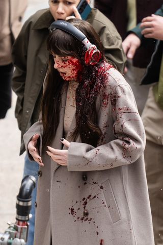 A photo of Johnson sporting short black nails while filming the bloody opening scene of Verity in New York City.