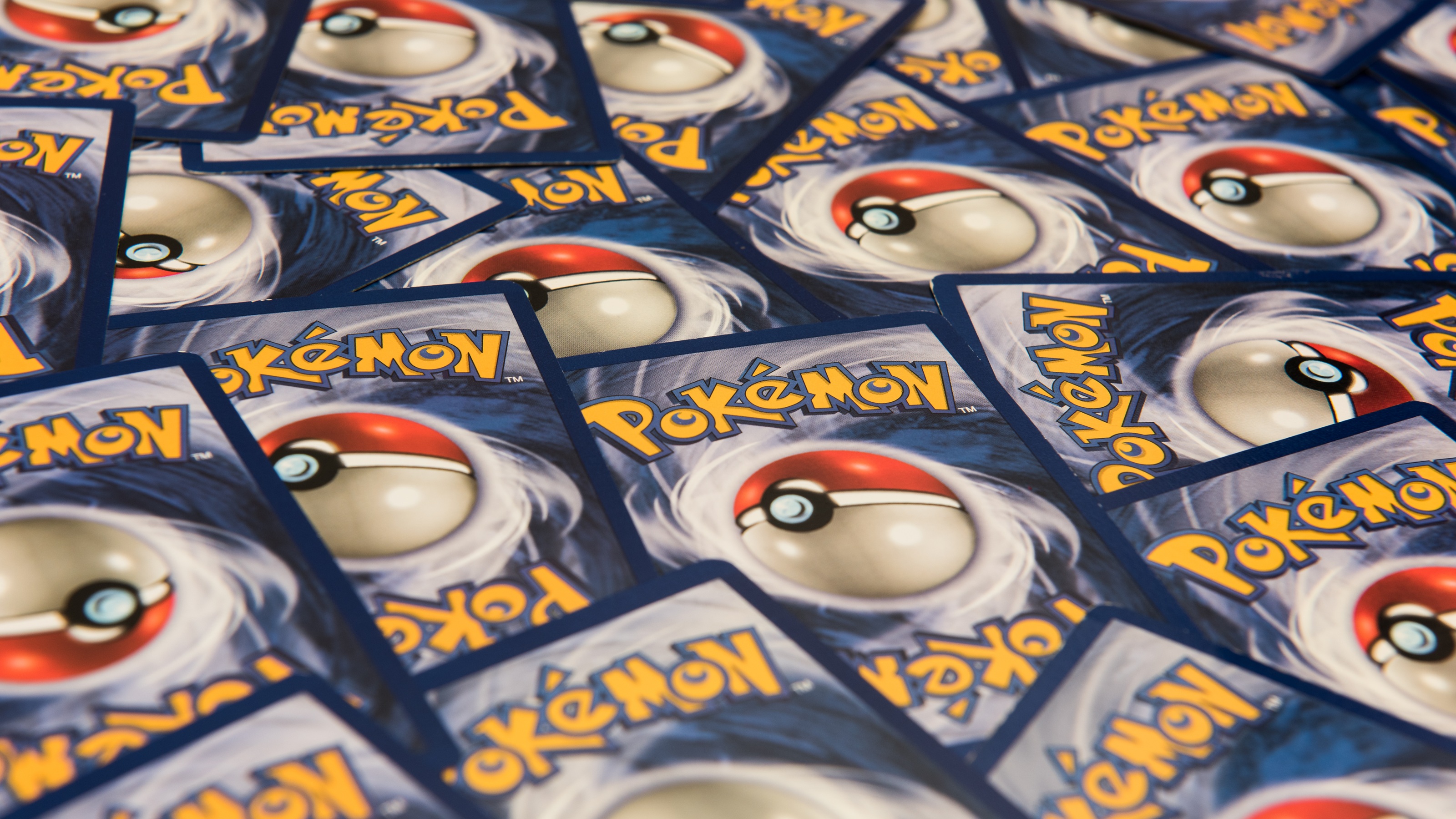 Many Pok&amp;eacute;mon cards scattered around.