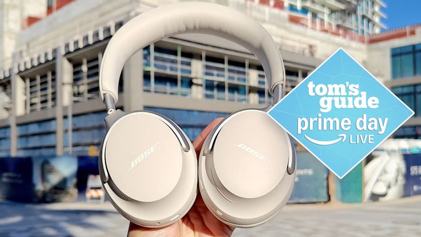 Bose QuietComfort Ultra headphones in hand with Prime Day deal tag
