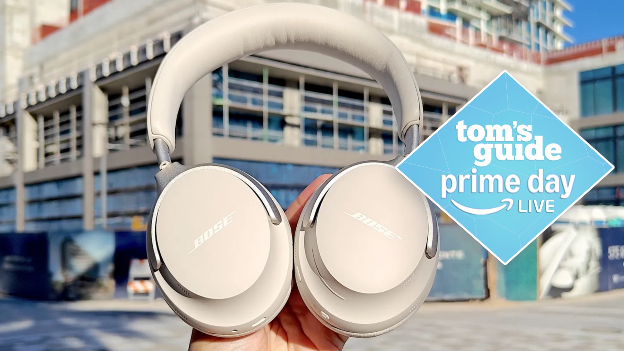 Bose QuietComfort Ultra headphones in hand with Prime Day deal tag