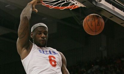 Lebron James slam dunks during a charity game