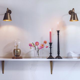 Harvey Jones traditional kitchen with shelf dressed with candles and flowers and brass wall lights