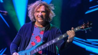 Yes bassist Billy Sherwood solo live shot from 2021 with a blue bass guitar and floral top