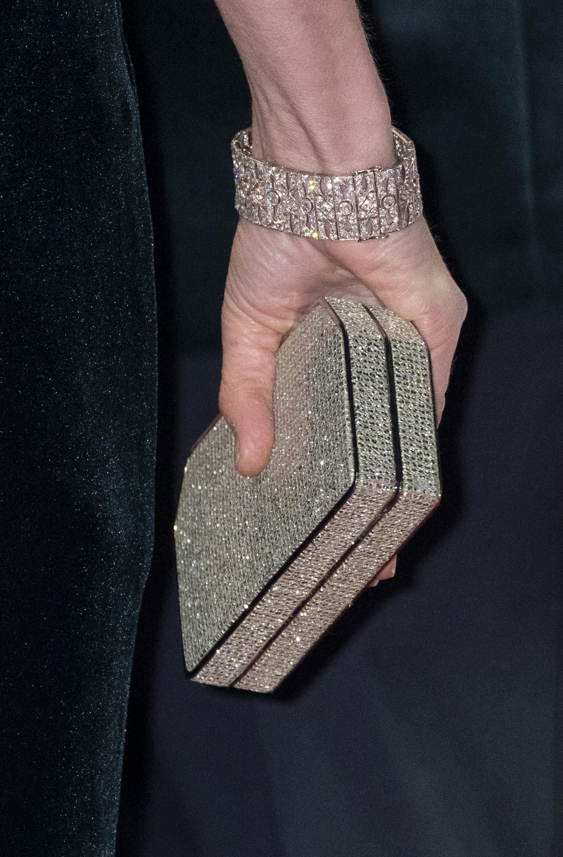 Kate Middleton&#039;s hand wearing a diamond bracelet and rhinestone clutch