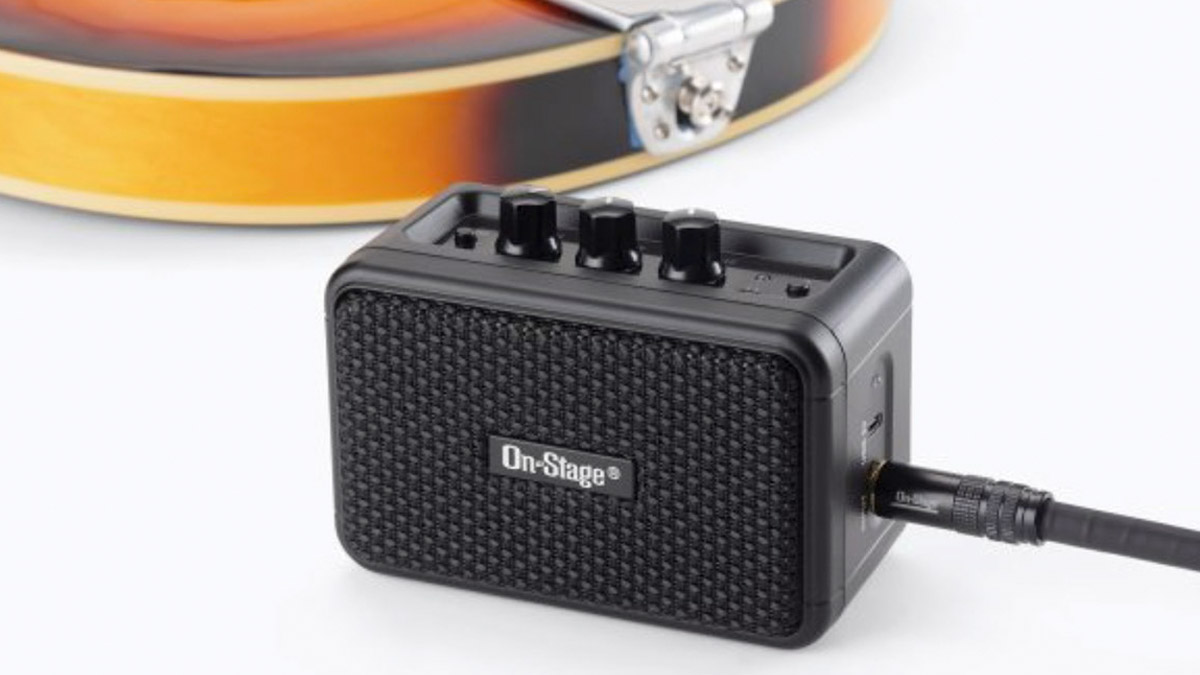 On-stage Travel Guitar Amplifier pictured with a semi-hollow electric guitar