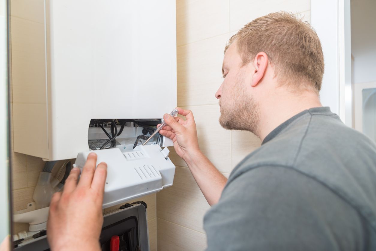 man fixing a boiler