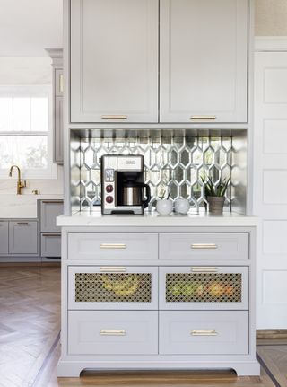 white kitchen with mirrored tiled backsplash