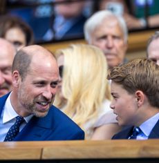 Prince George sitting next to Prince William at Wimbledon, both wearing blue suits