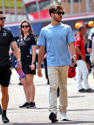 Pierre Gasly wearing a Berluti blue shirt and khaki trousers with sneakers at the Monaco Grand Prix.