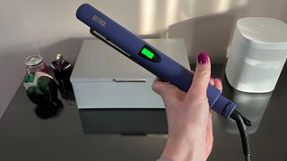 The Hot Tools Pro Signature Digital Straightener being held with the display facing upwards