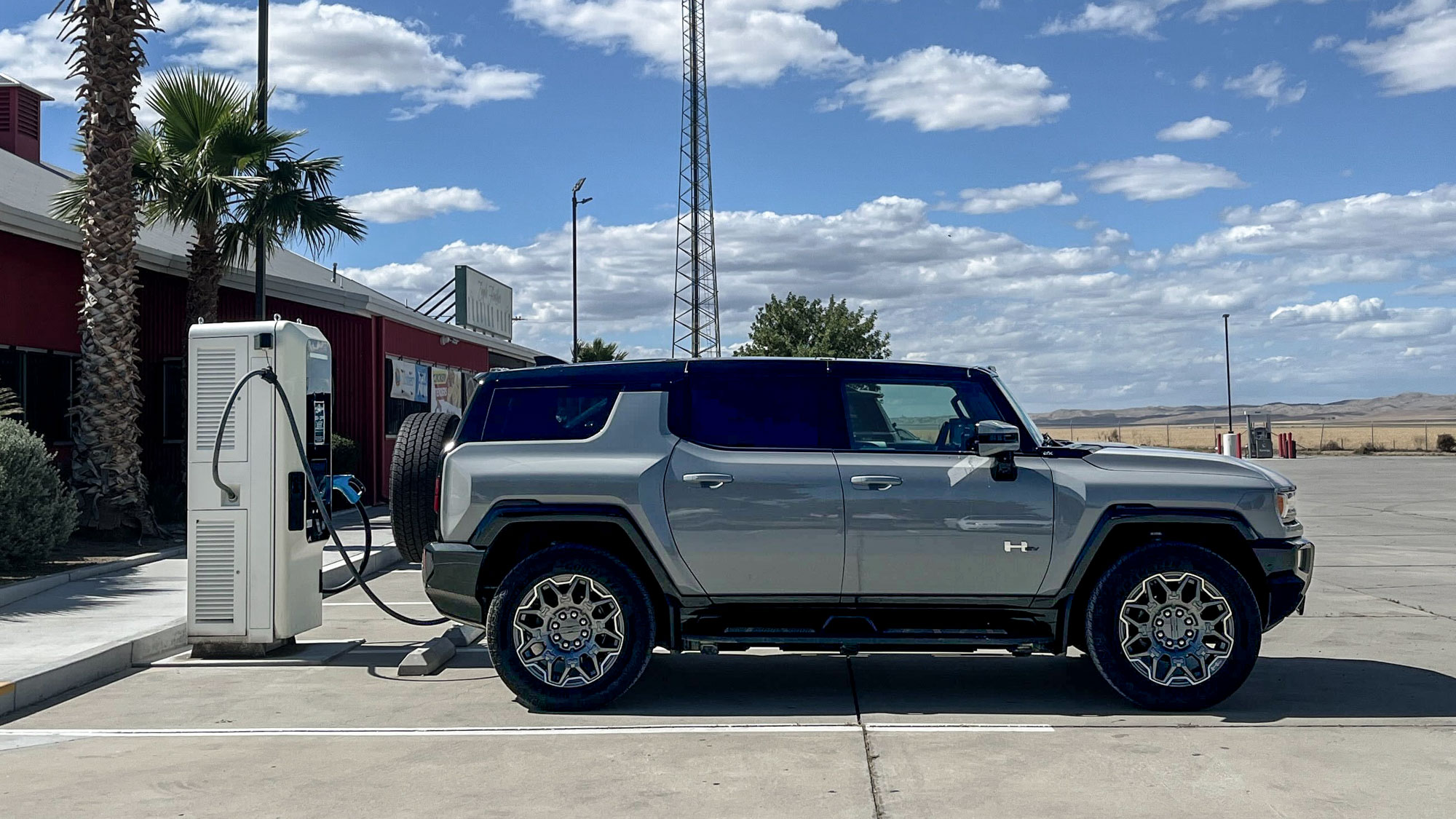 2025 GMC Hummer EV 3X SUV parked at a charging station