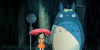 Satsuki Kusakabe and Totoro standing in the rain in My Neighbor Totoro