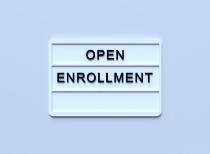 ''Open Enrollment'' Written White Lightbox Sitting On Blue Background