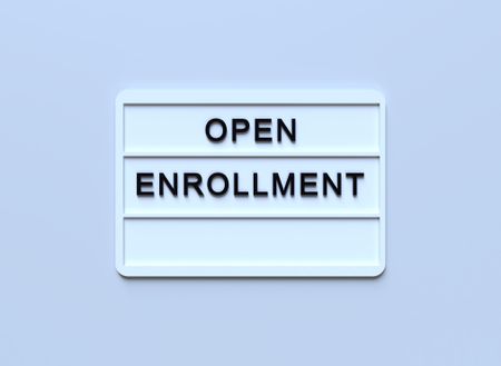 ''Open Enrollment'' Written White Lightbox Sitting On Blue Background