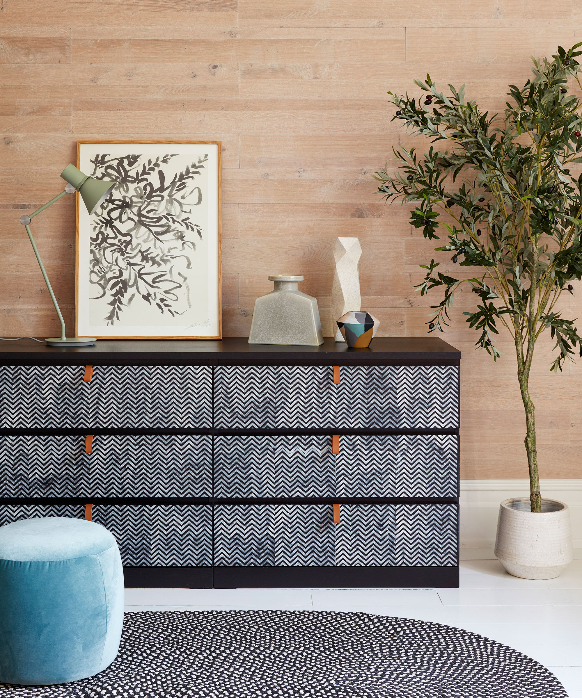 drawers with potted plant and floor mat