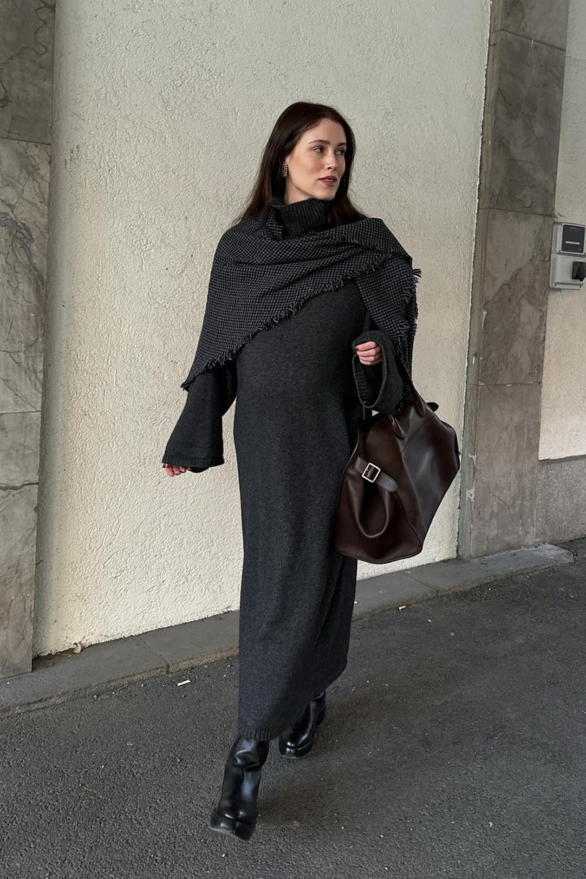 Woman wearing a knit dress and boots.