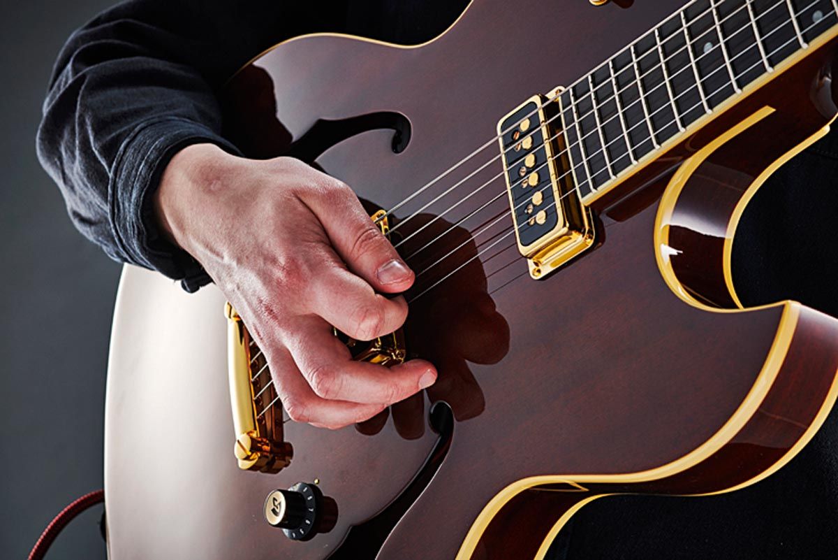 For more control, Joe often anchors a couple of free fingers on the body near the bridge pickup. Picking near the bridge gives bite to his tone.