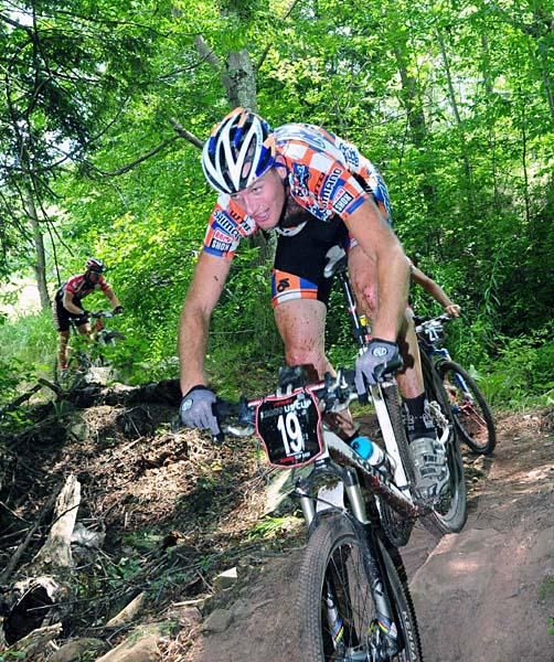 Kris Sneddon (Kona) is followed closely by two other racers.
