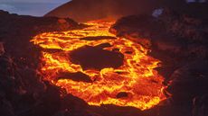 a lava flow with dark sky in the background