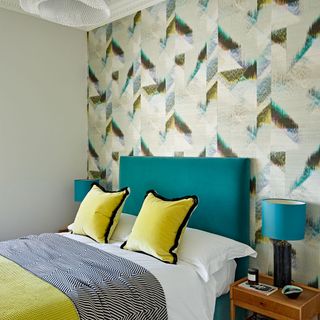 guest room with yellow cushion and sky blue table lamp