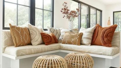 An example of the best throw pillows on a cushioned bench.