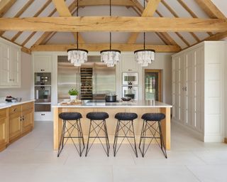 Kitchen with wood and painted cabinets and island by Martin Moore