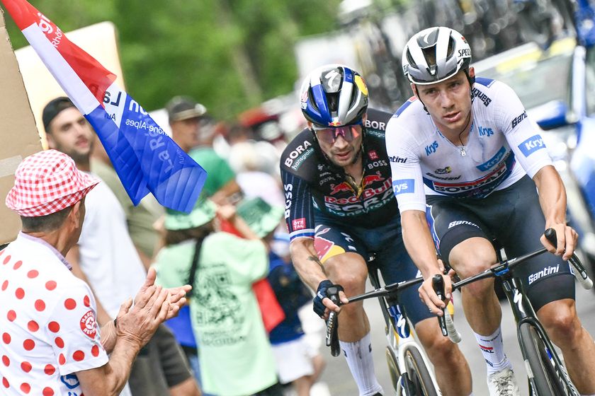 Soudal Quick-Step team&#039;s Belgian rider Remco Evenepoel wearing the best young rider&#039;s white jersey and Red Bull - BORA - hansgrohe team&#039;s Slovenian rider Primoz Roglic cycle in a pursuing group in the final kilometers of the 11th stage of the 111th edition of the Tour de France cycling race, 211 km between Évaux-les-Bains and Le Lioran, on July 10, 2024. (Photo by Marco BERTORELLO / AFP) (Photo by MARCO BERTORELLO/AFP via Getty Images)