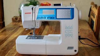 A photo of a sewing machine on a wooden table