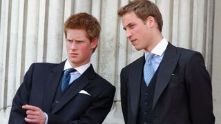 Prince William and Prince Harry stand on the balcony of Buckingham Palace after Trooping the Colour on June 14, 2003 in London, England