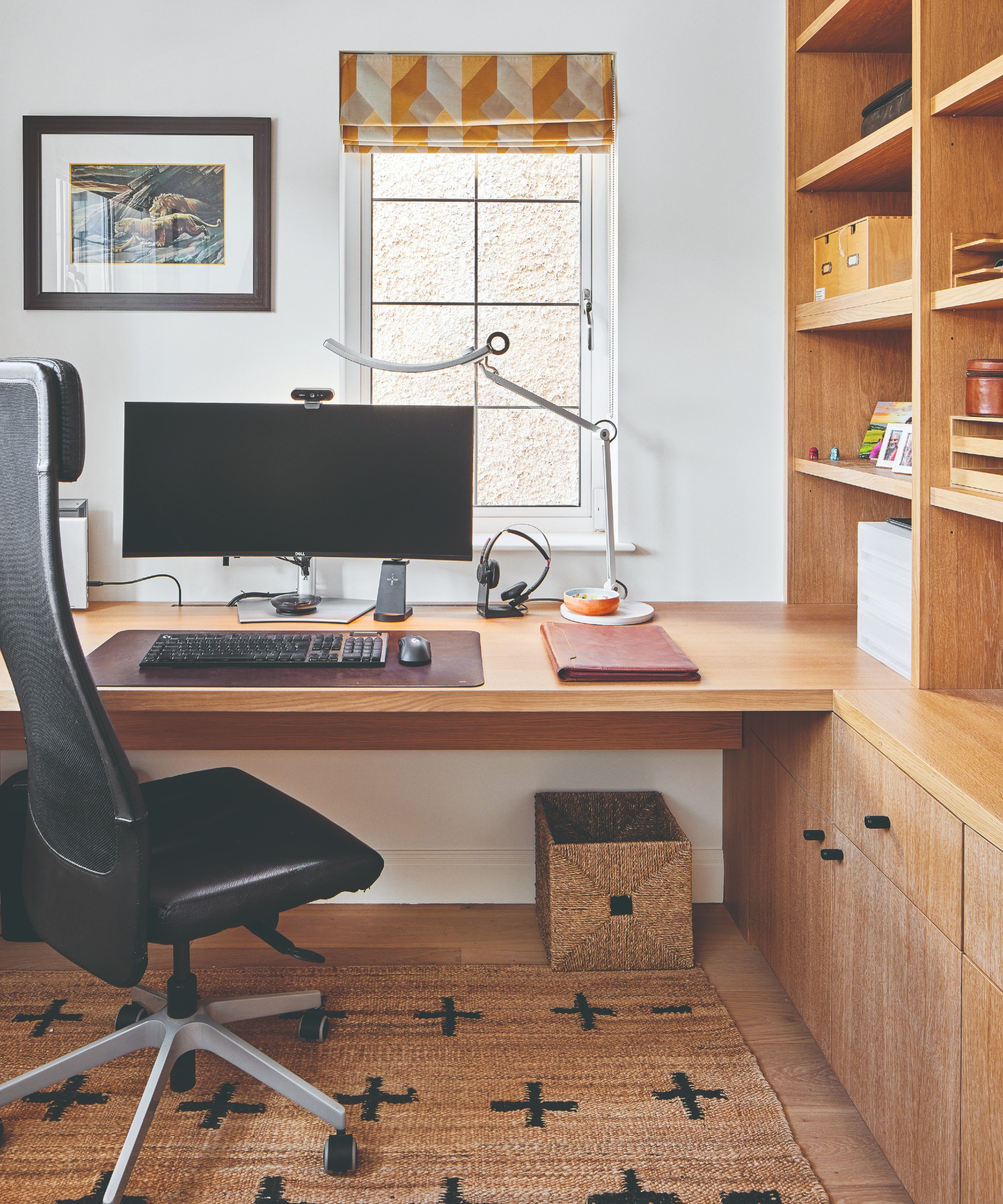 A home office with a built-in desk and storage and an ergonomic office chair