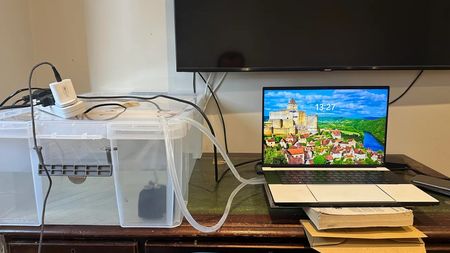 Razer Blade 16 with giant cooler attached, the cooler is made from a plastic storage crate