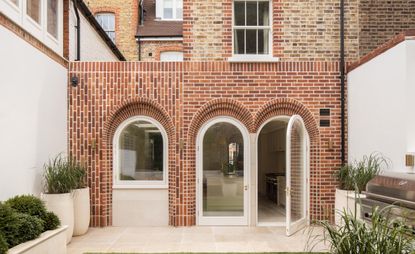 Arch house by Flower Michelin, rear exterior, defined by brick arch architecture