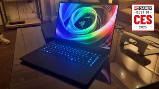 The Razer Blade 16 on a glass table at CES 2025, with the PC Gamer Best of CES 2025 logo in the top right.