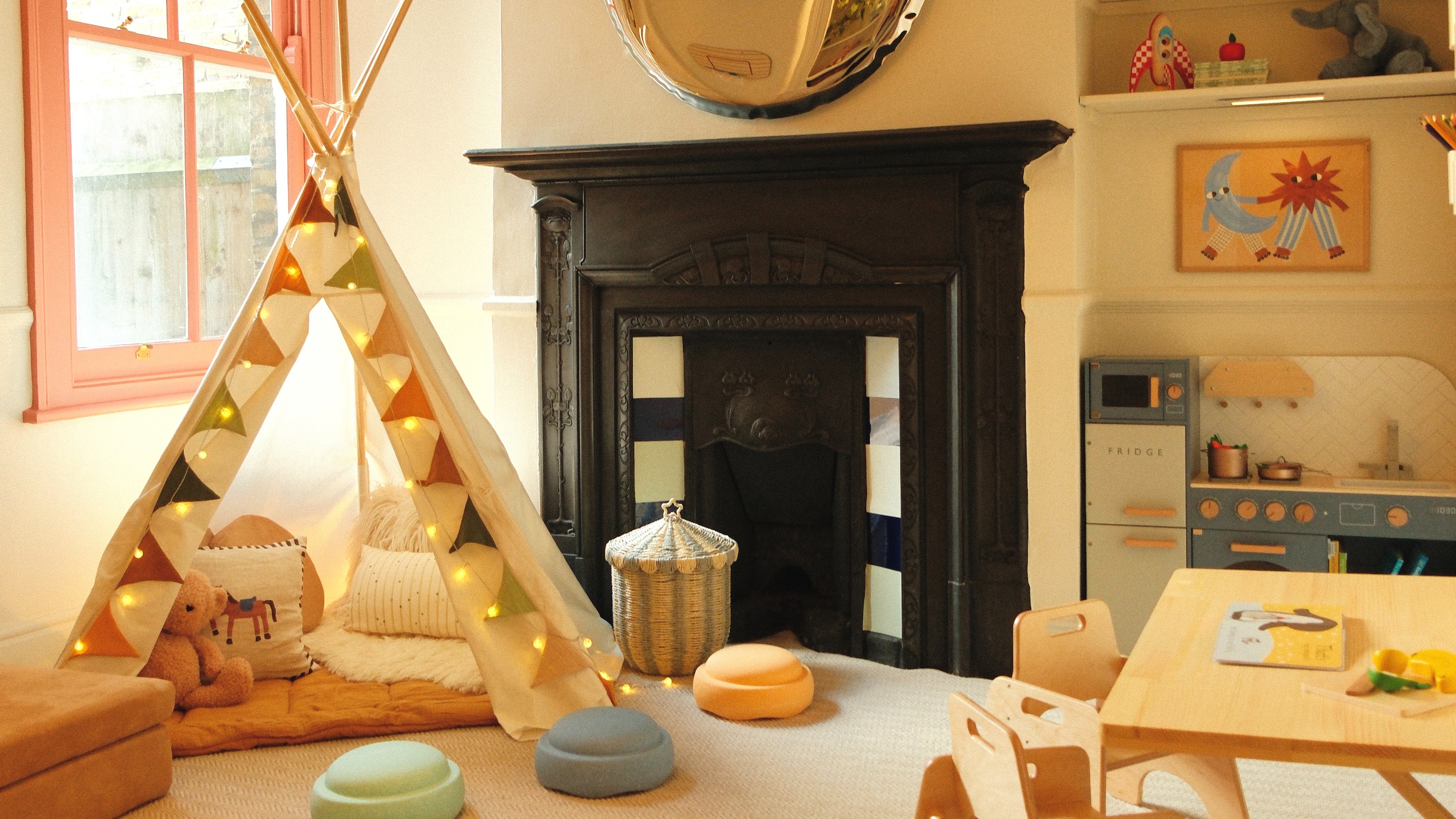 Zac's playroom designed by Tash Bradley with a teepee tent and a blue play kitchen