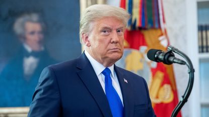 TOPSHOT - US President Donald Trump looks on during a ceremony presenting the Presidential Medal of Freedom to wrestler Dan Gable in the Oval Office of the White House in Washington, DC on December 7, 2020. (Photo by SAUL LOEB / AFP) (Photo by SAUL LOEB/AFP via Getty Images)