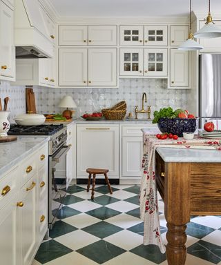 Cozy cottage kitchen with chequerboard floors, an antique wooden island, and a mix of new and old decor