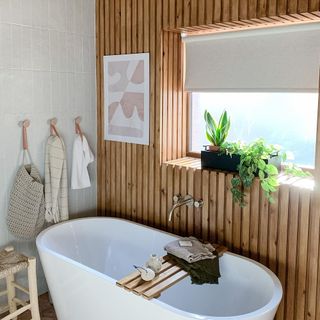bathroom with white tile wall and bathtub