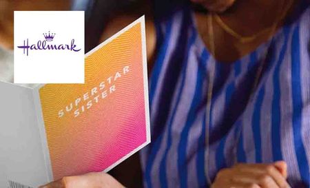 hallmark logo top left with a person reading card