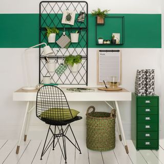 room with green and white wall and white desk and green drawer and metallic frame pegboard