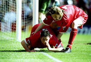Robbie Fowler is pulled away by Liverpool team-mate Steve McManaman after mimicking cocaine snorting to celebrate his first goal against Everton in April 1999.