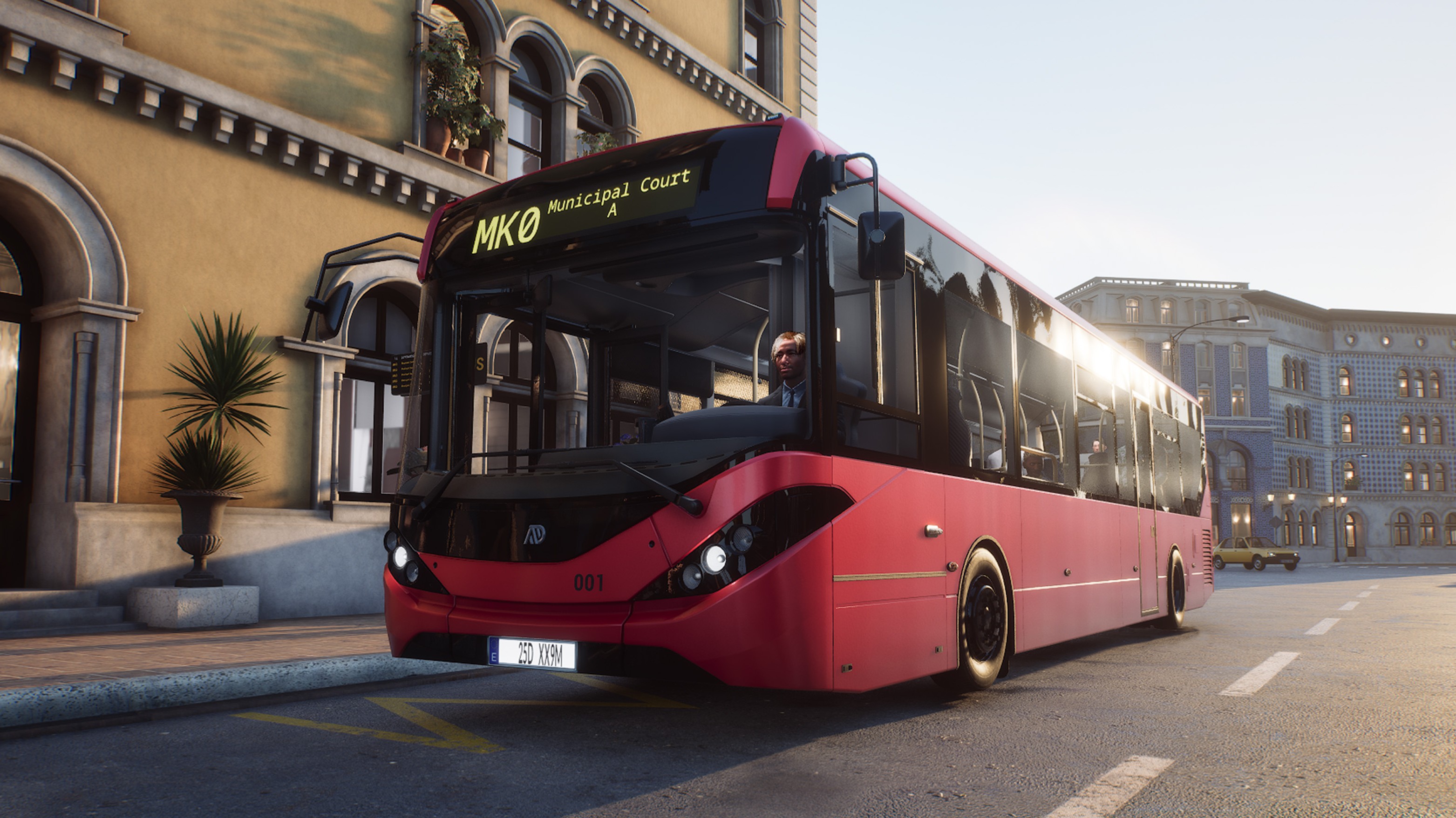 A Bus Simulator 27 screenshot showing a small red bus in a Spanish street.