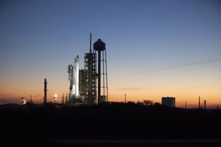 The sun sets over SpaceX's Falcon 9 rocket atop NASA's Kennedy Space Center Launch Pad 39A in Cape Canaveral, Florida on Feb. 16, 2017 ahead of the company's 10th cargo delivery mission to the International Space Station for the space agency.