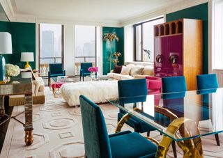 living room dining room combo with blue chairs and green walls