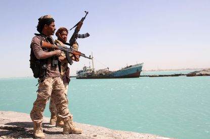 Pro-government forces work a Yemen port.